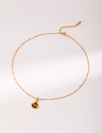 10mm genuine Tiger Eye stone with mesmerizing chatoyant effect resembling moving feline eye in vintage setting.