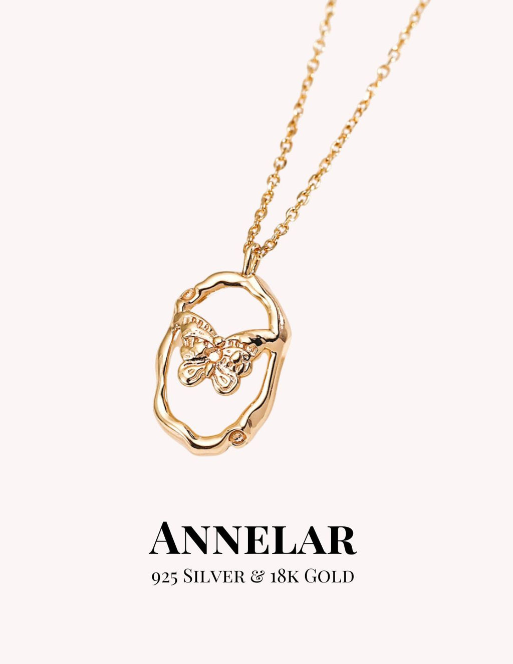 Gold necklace with butterfly pendant on a white background, featuring the brand 'ANNELAR'.