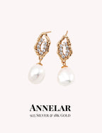 Pair of pearl earrings with gold accents on a white background, featuring the brand 'ANNELAR'.