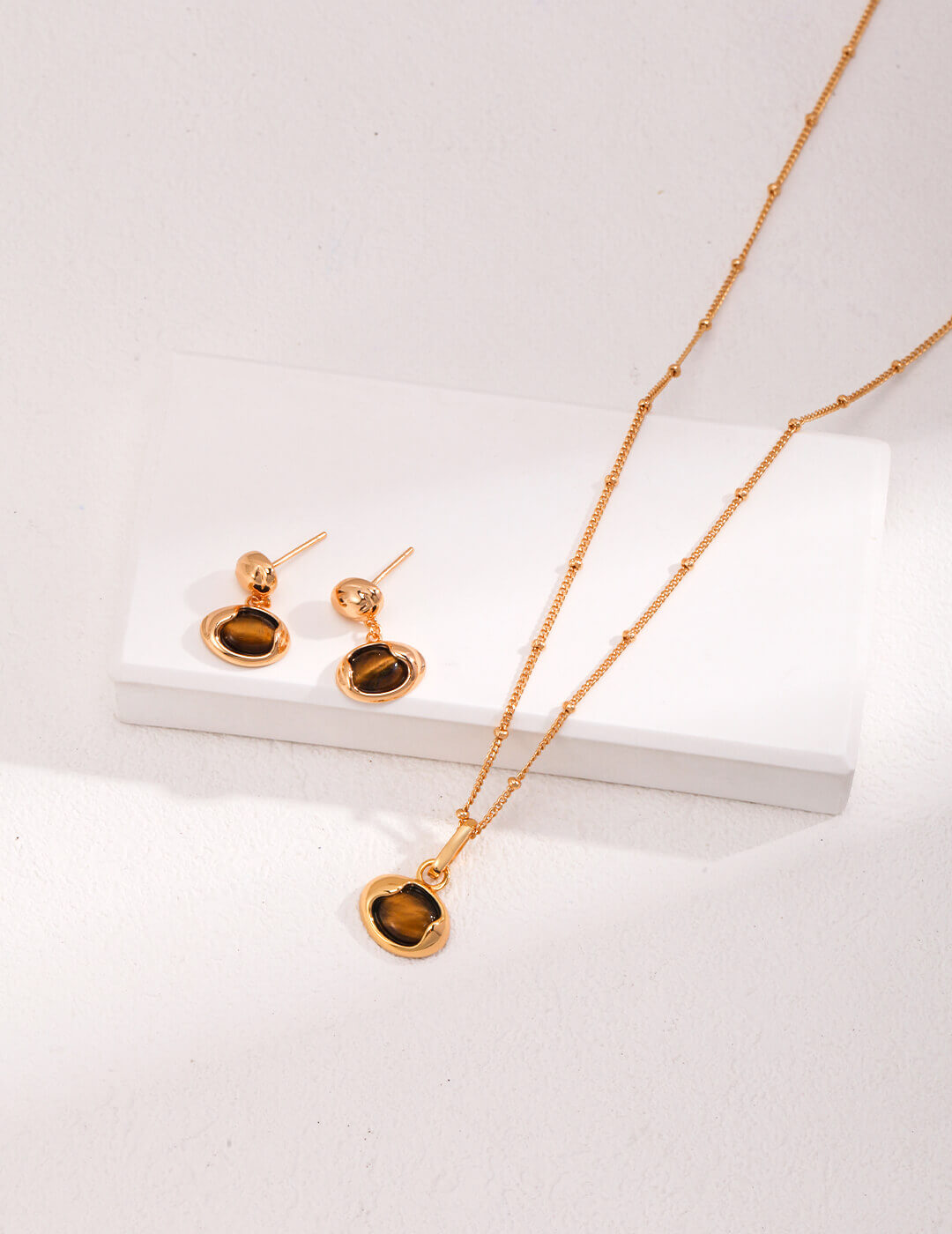 Tiger Eye jewelry set showing coordinated necklace and earrings with elegant vintage gold finish.