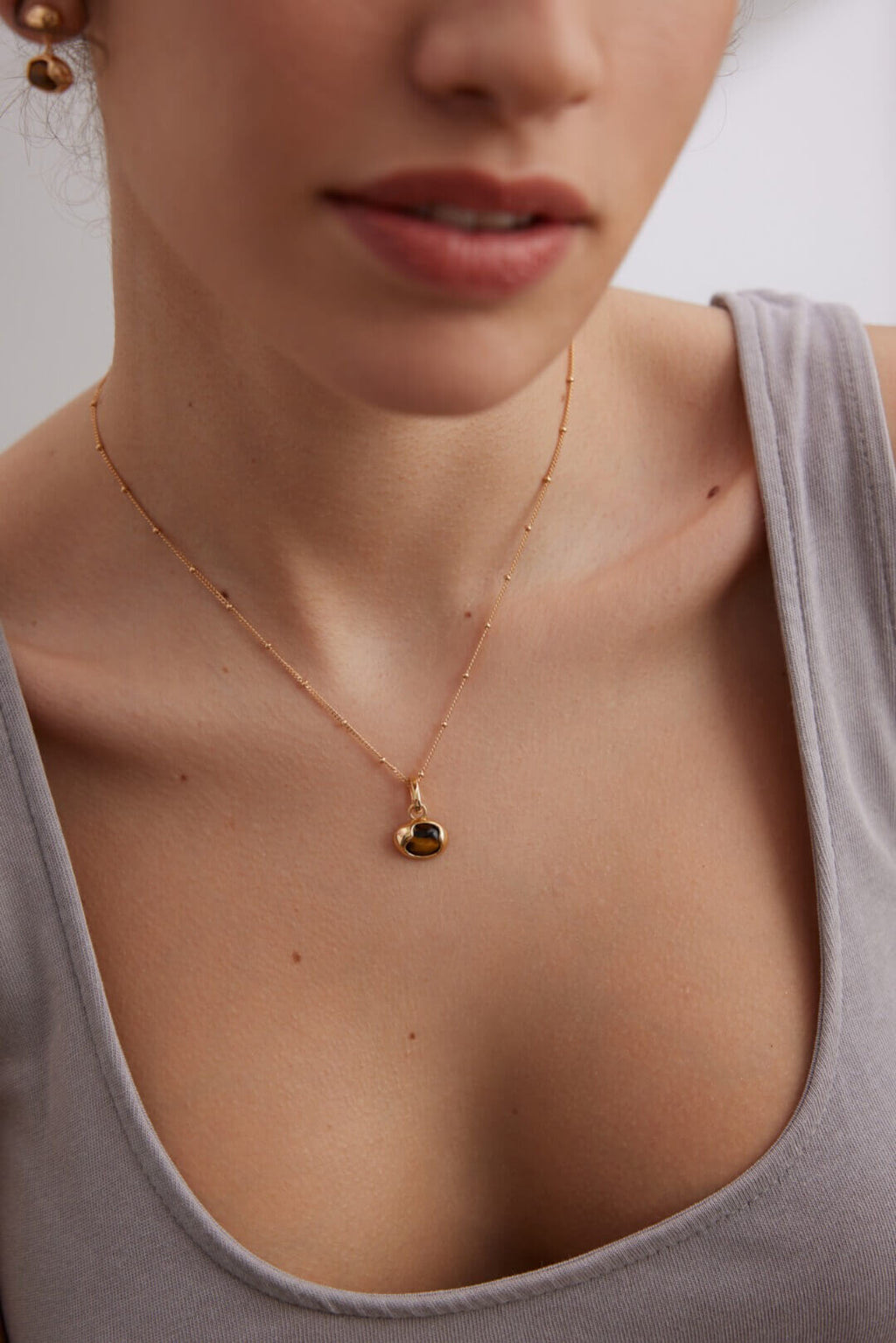 Versatile Tiger Eye jewelry set beautifully complementing various skin tones with warm gold finish.