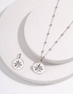 Silver necklace with star pendant on a white background