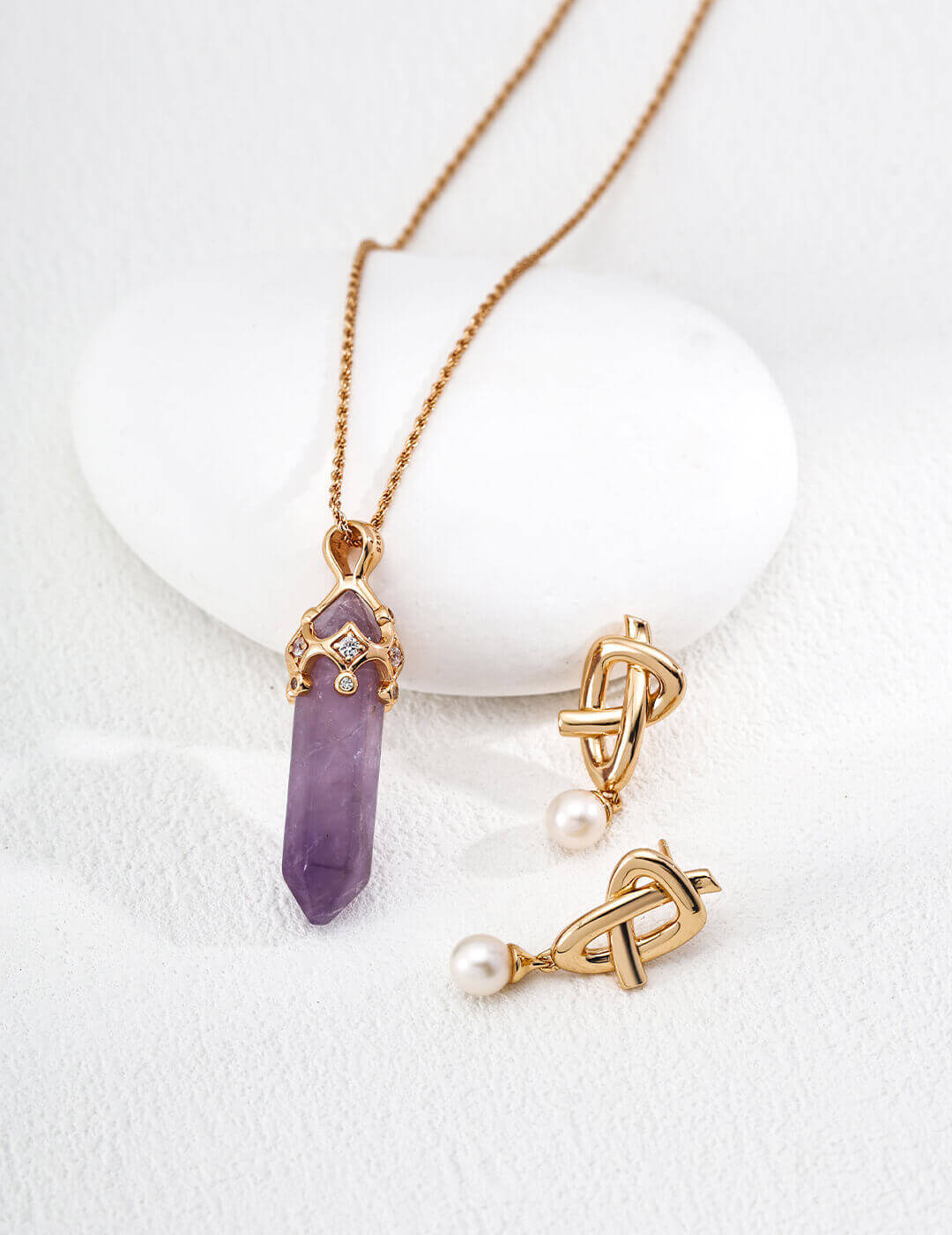 Close-up shot of the crown pendant, highlighting the raw amethyst and zirconia details.