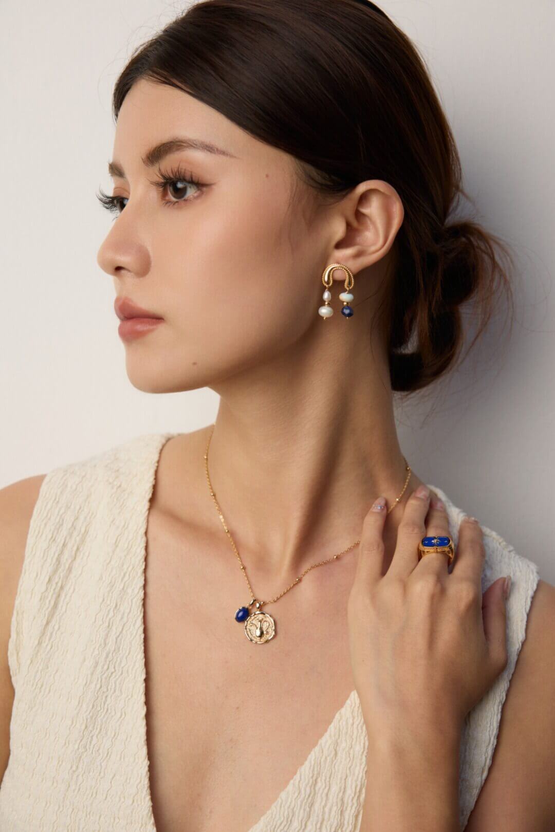 Model in a creative workspace wearing the artistic earrings, embodying cultural depth and bohemian spirit.