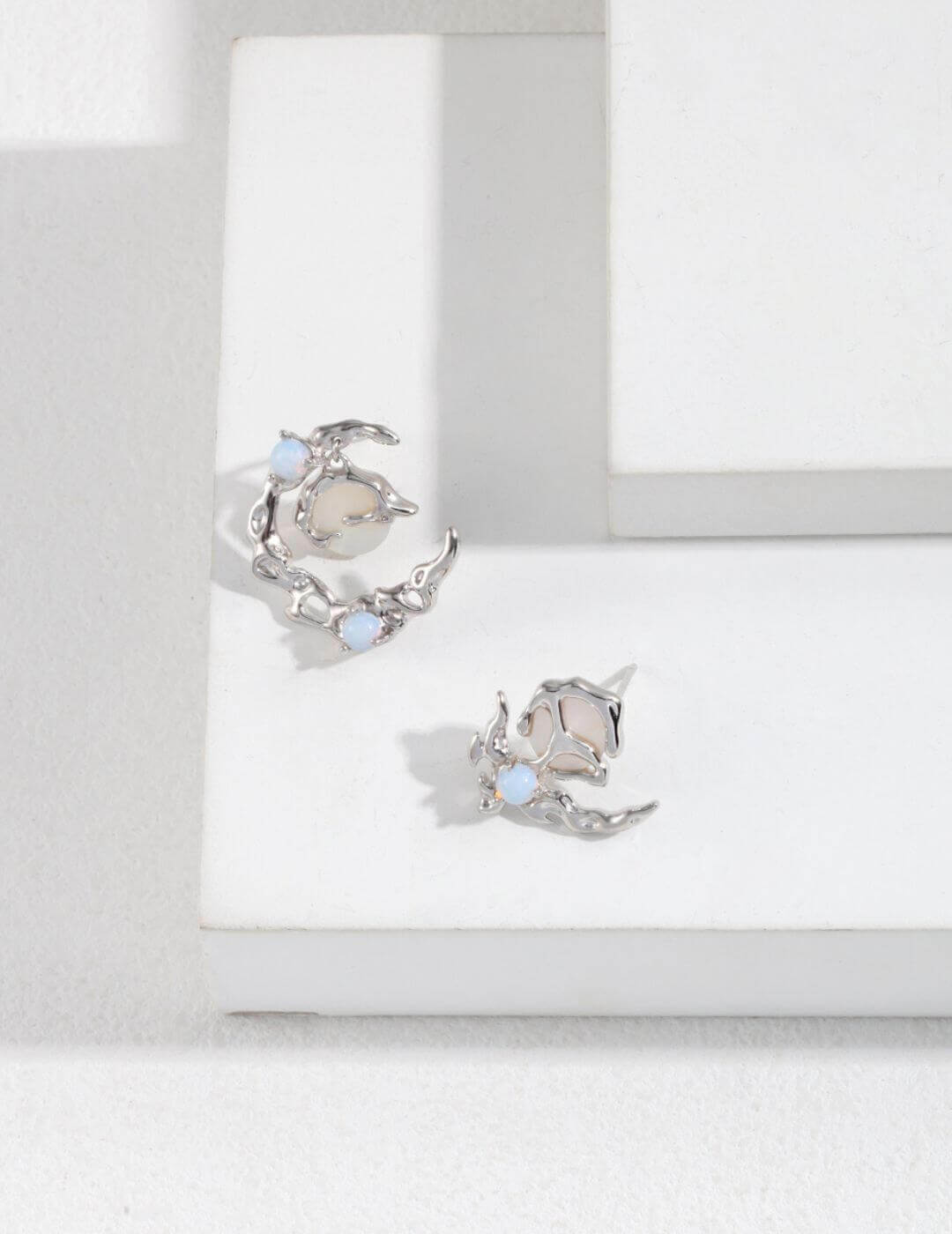 Front view of asymmetric opal and mother of pearl earrings in S925 silver