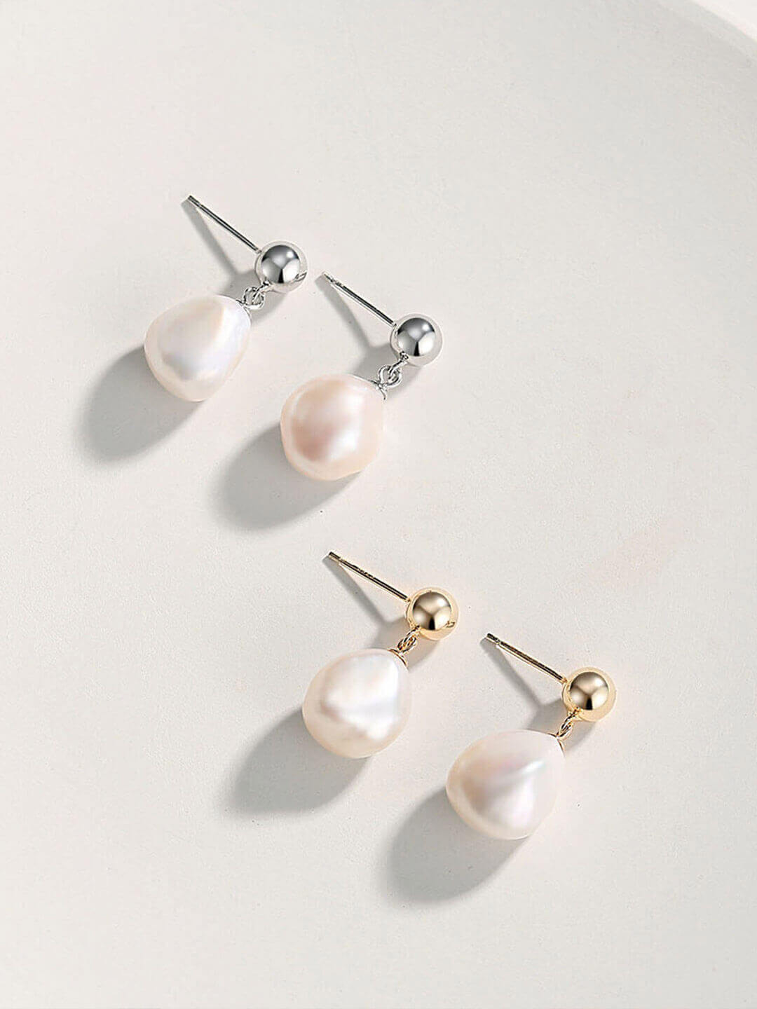 Close-up detail of the unique, irregular-shaped baroque natural pearls on the vintage sterling silver earrings.