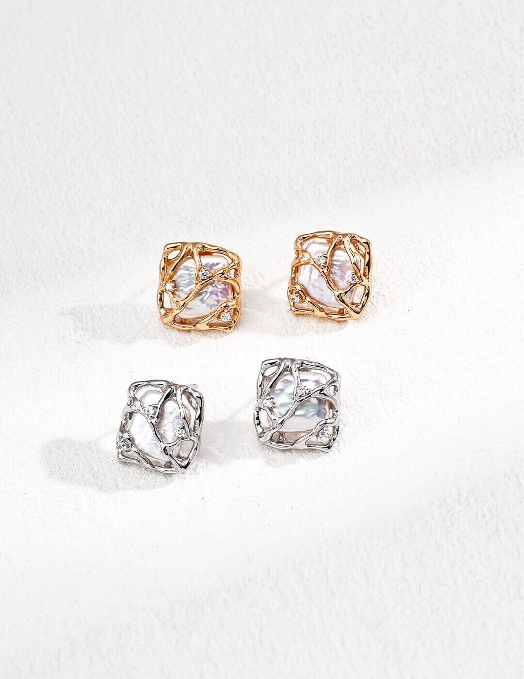 Four gold and silver ringlets on a white background