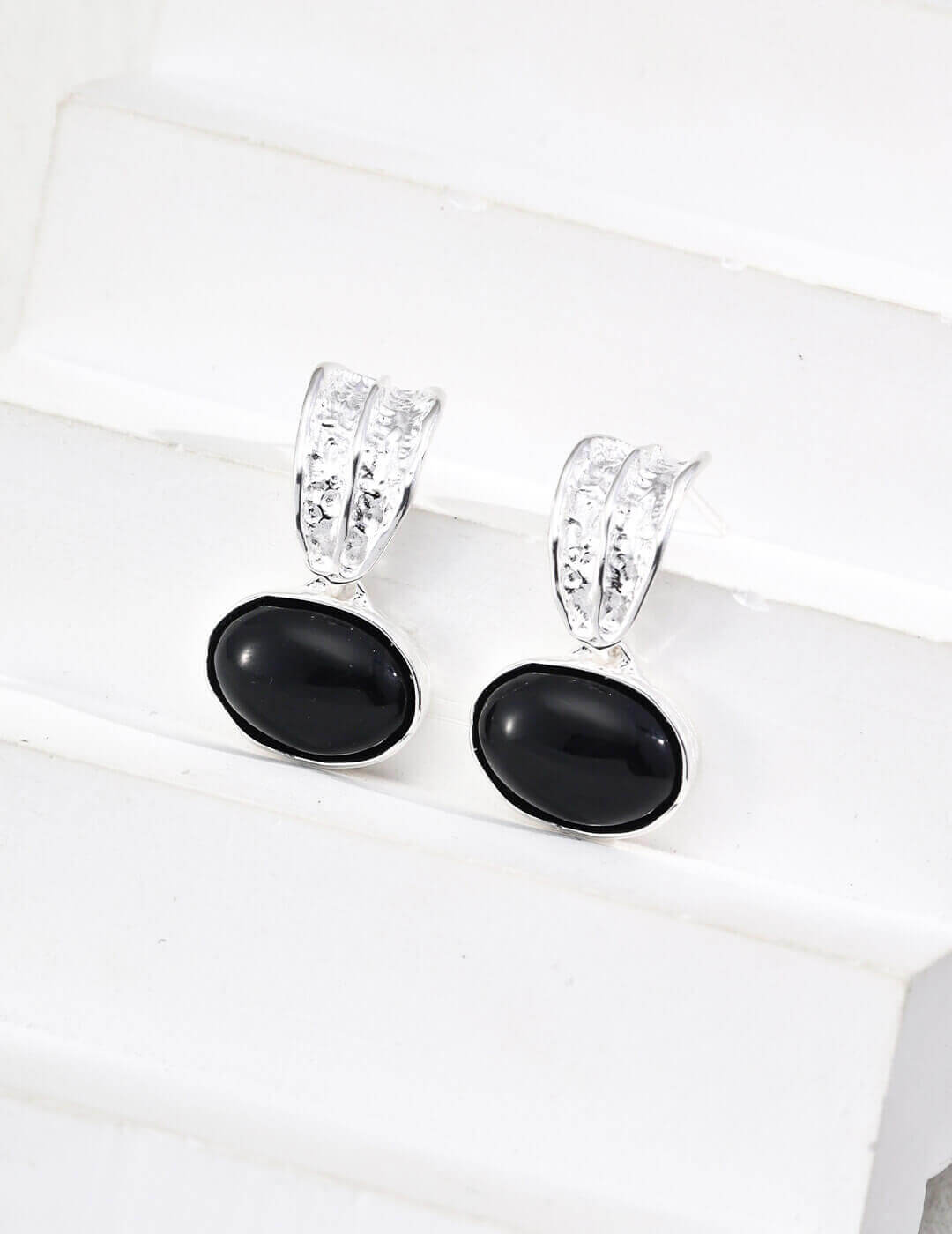 Side view of Black Onyx earrings on model, showcasing sophisticated black gemstones against skin tone.