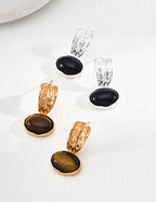 The Black Onyx and Tiger's Eye series: two pairs of S925 sterling silver earrings showcasing natural gemstones with unique textured craftsmanship.