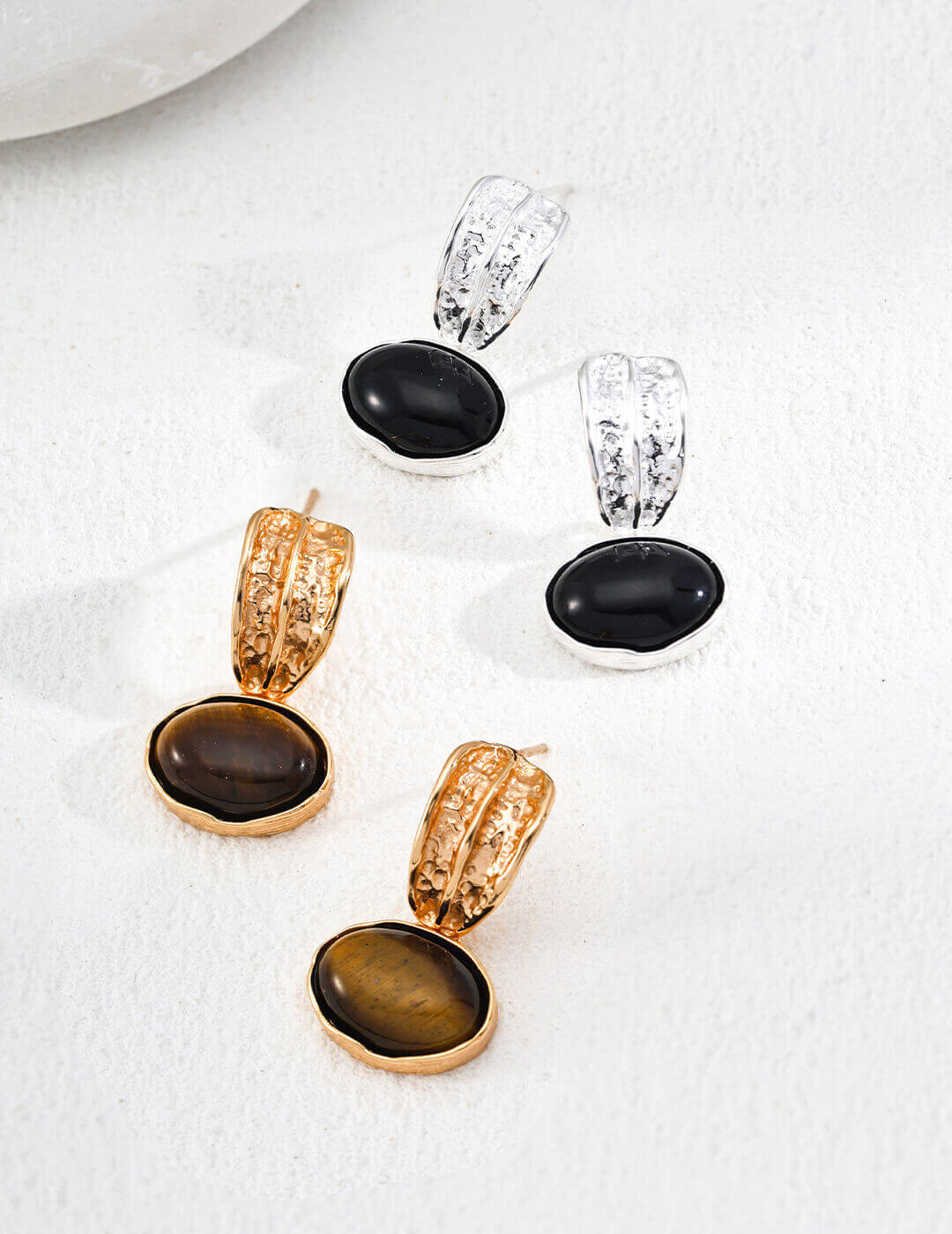 The Black Onyx and Tiger's Eye series: two pairs of S925 sterling silver earrings showcasing natural gemstones with unique textured craftsmanship.