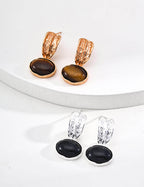 Close-up comparison of deep black onyx and golden brown tiger's eye gemstones, highlighting their vibrant colors and natural patterns.