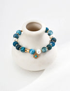 Front view of the Blue Harmony necklace, featuring a natural white pearl centered with raw azurite and turquoise gemstones on a silver chain.