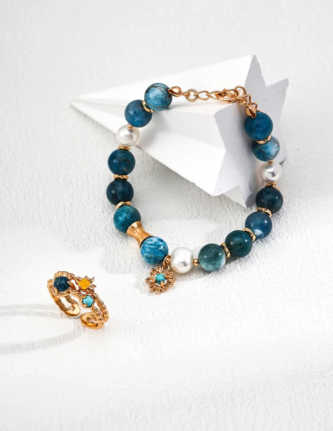 Detailed close-up of Blue Harmony bracelet, showcasing the vibrant blue turquoise and smooth pearl dangling from sterling silver.