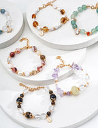 Macro photography highlighting the color and texture contrast between the red agate, pearl, and crystal beads.