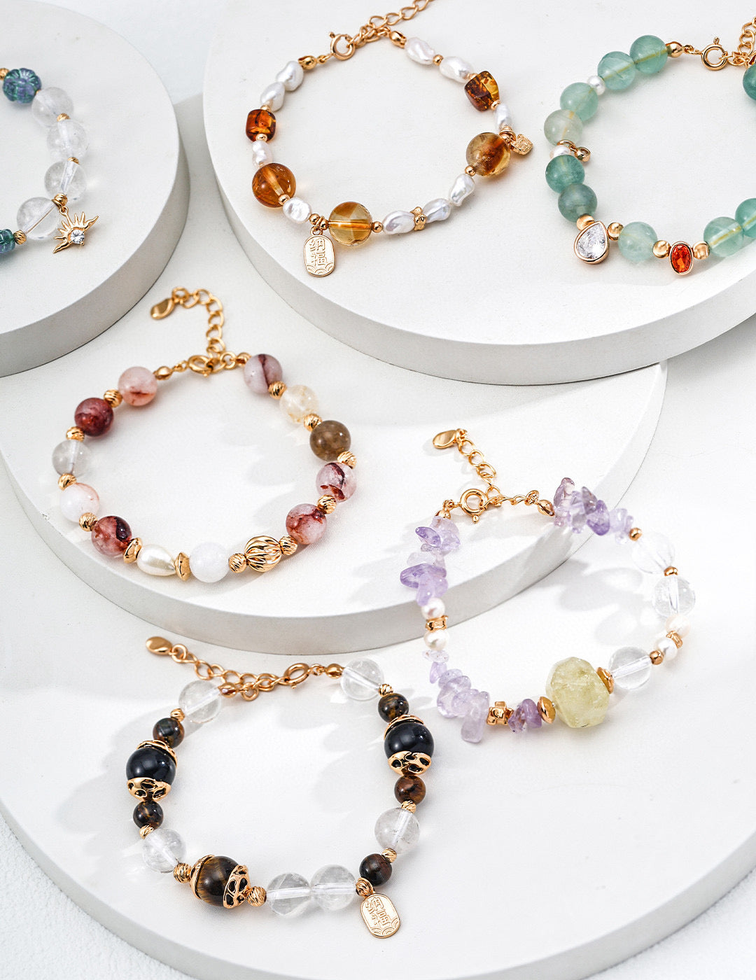 Macro photography highlighting the color and texture contrast between the red agate, pearl, and crystal beads.