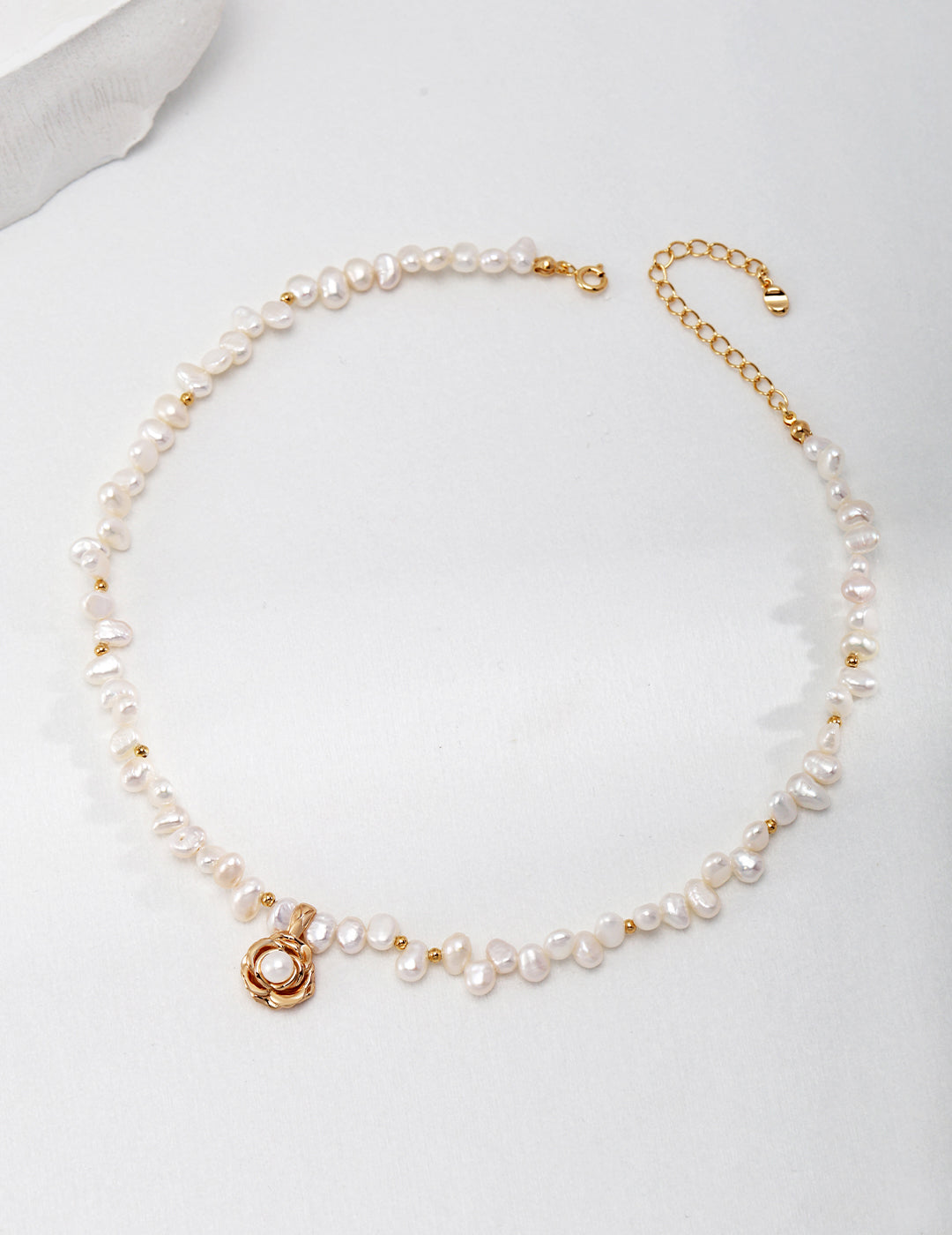 Close-up of the exquisite camellia-shaped pendant with natural pearls in S925 silver.