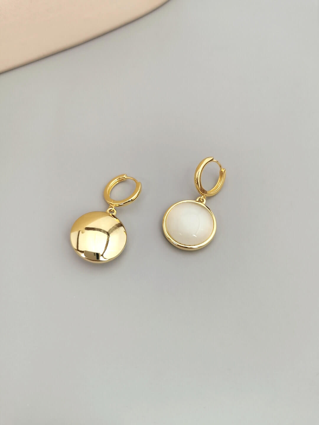 Back view showing secure closure of cat's eye stone drop earrings.