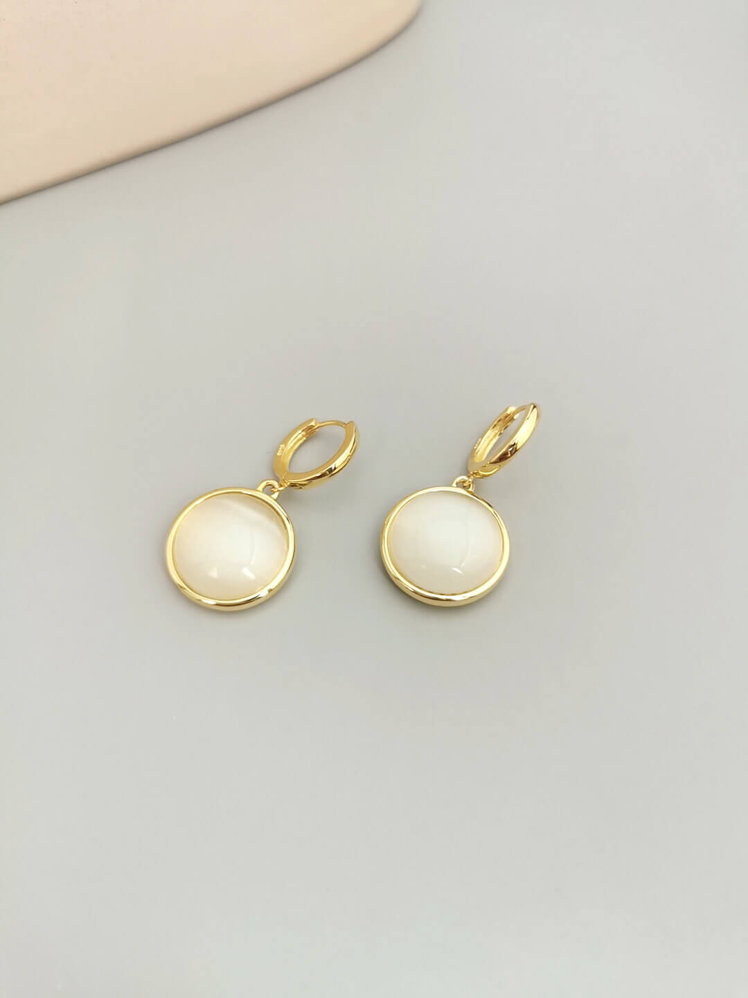 Cat's eye stone earrings from different angles showing light play.