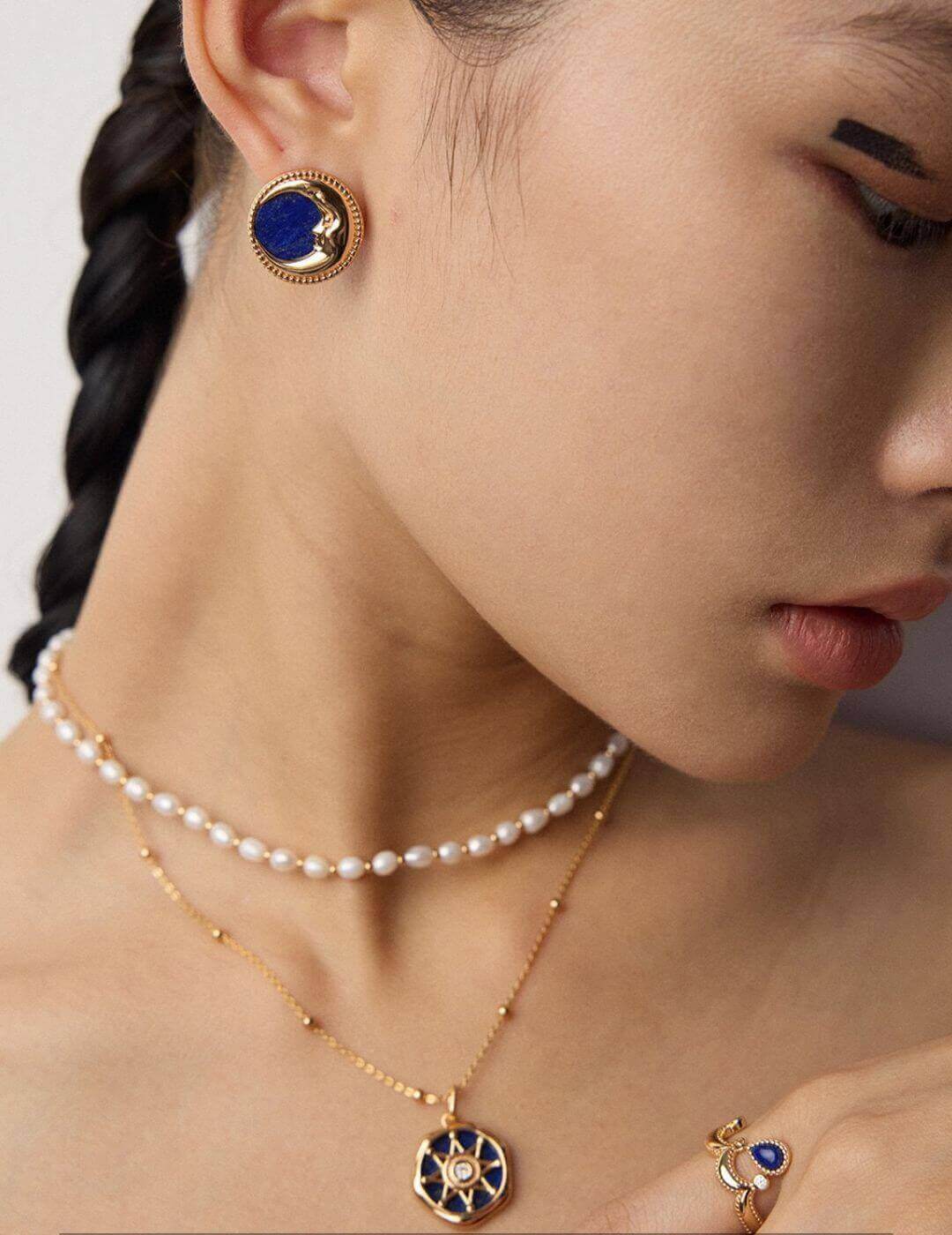 Design inspiration board for vintage Lapis Lazuli earrings, featuring deep blue stones with golden pyrite specks that resemble a starry night sky.