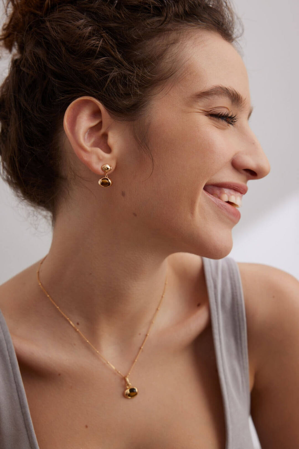 Model wearing complete Tiger Eye set creating harmonious look that transitions from day to night.