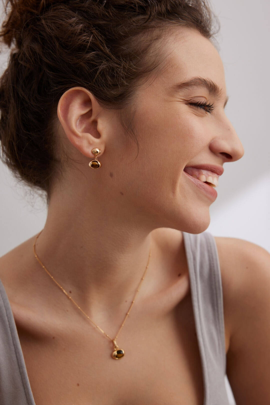 Model wearing complete Tiger Eye set creating harmonious look that transitions from day to night.