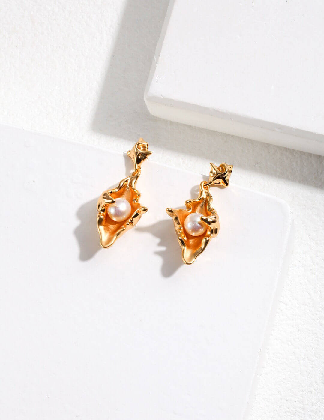Matching conch shell pearl earrings in sterling silver, capturing diverse forms of human romance.