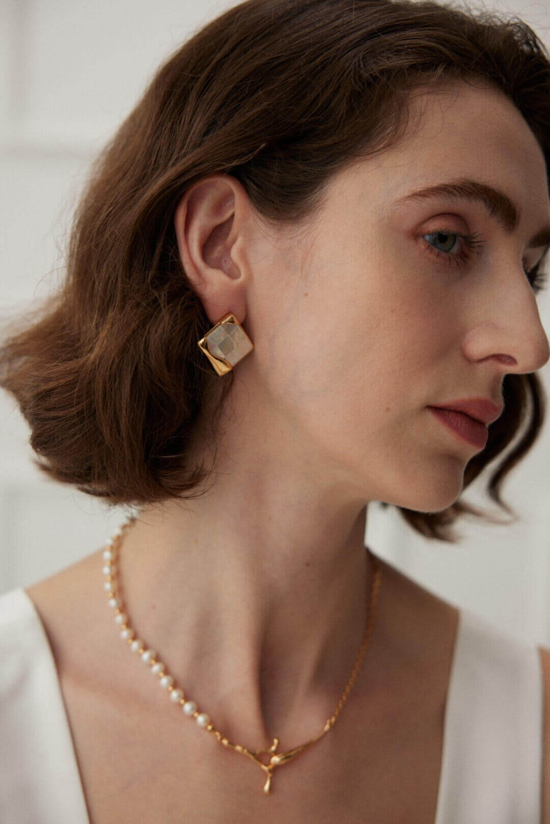 Mosaic shell earrings paired with casual outfit, adding artistic flair to everyday style.