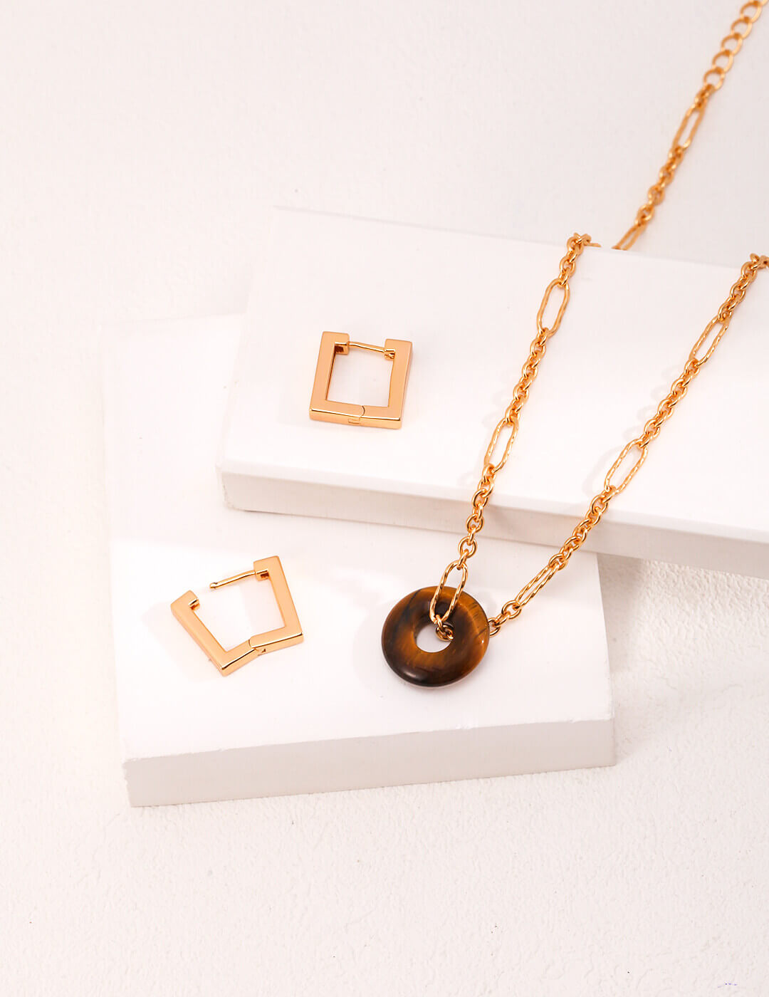Flat lay showing the three different ways to wear this convertible jewelry set.