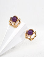Close-up detail of the fluently designed liquid metal seamlessly encasing the noble purple amethyst gemstone.