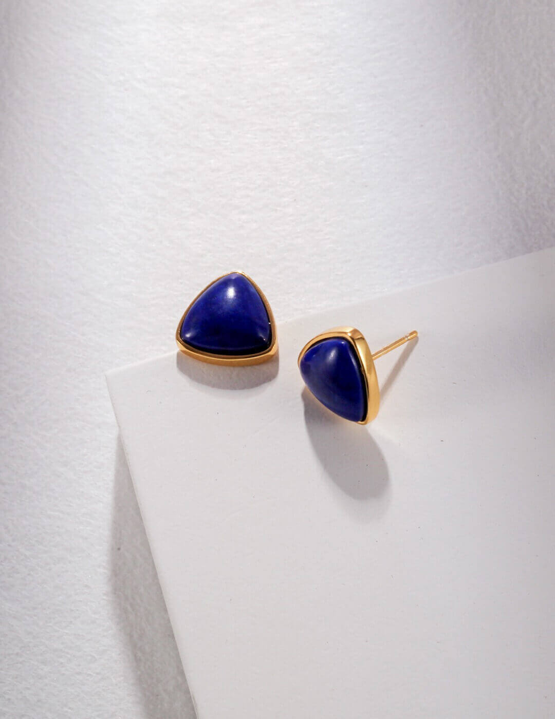 Close-up of genuine Lapis Lazuli stone with rich blue color and delicate golden pyrite specks, set in elegant sterling silver.
