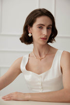 Front view of Greek-inspired mosaic shell earrings creating modern classic look on model