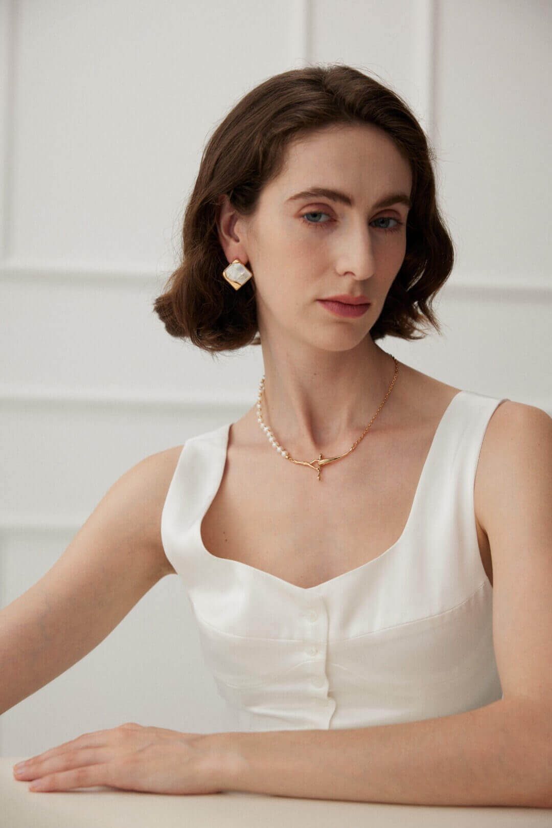 Front view of Greek-inspired mosaic shell earrings creating modern classic look on model