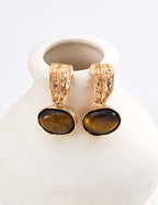 Golden brown Tiger's Eye gemstone with natural banding patterns, enhanced by textured craftsmanship.