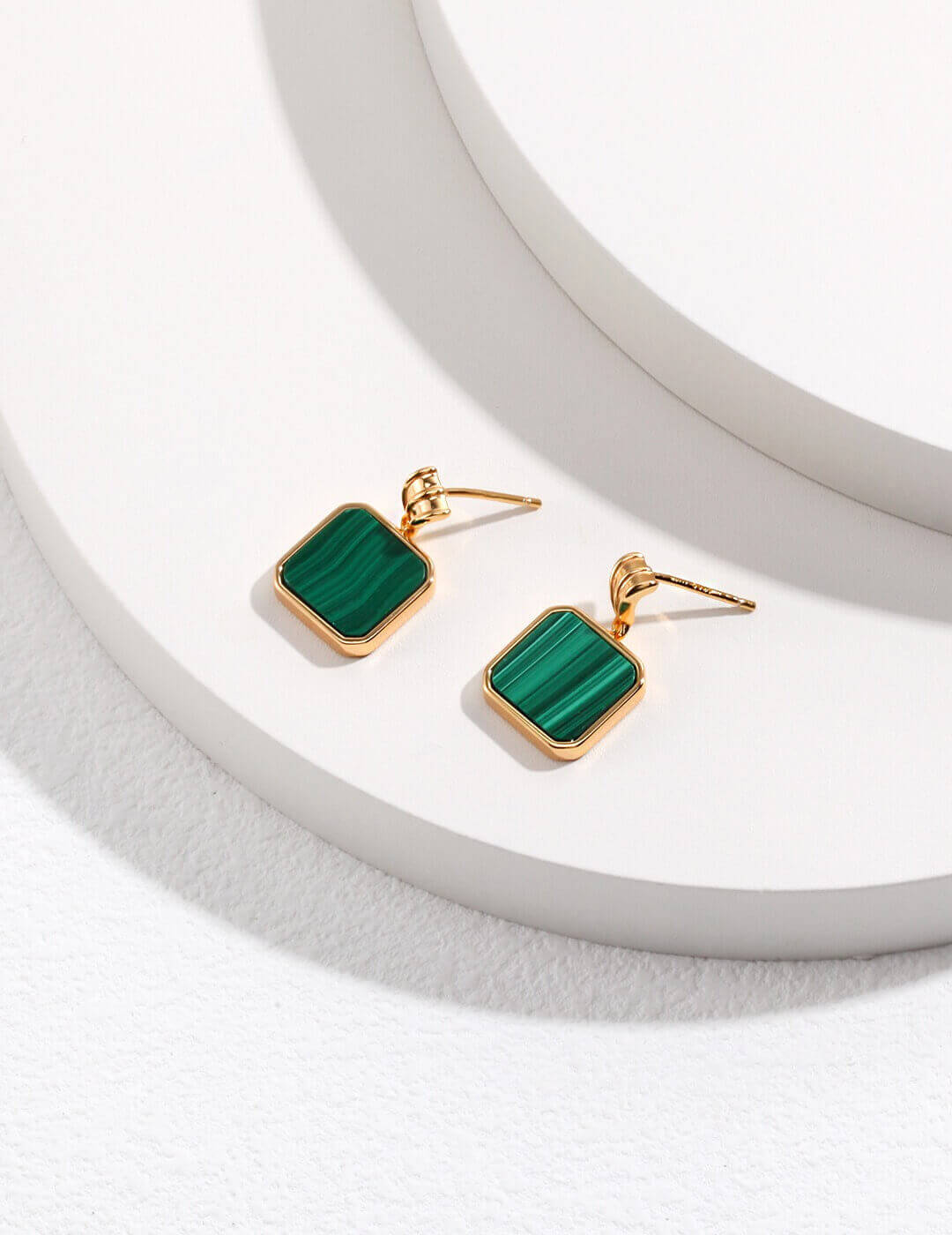 Close-up of the green malachite gemstone, showcasing its vibrant patterns and romantic, fresh elegance.
