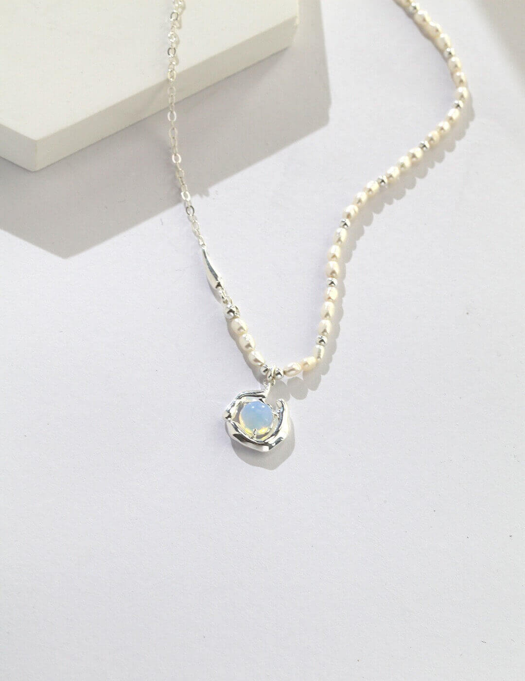 Irregular fluid-shaped sterling silver setting handcrafted to resemble mountains guarding a pure land.