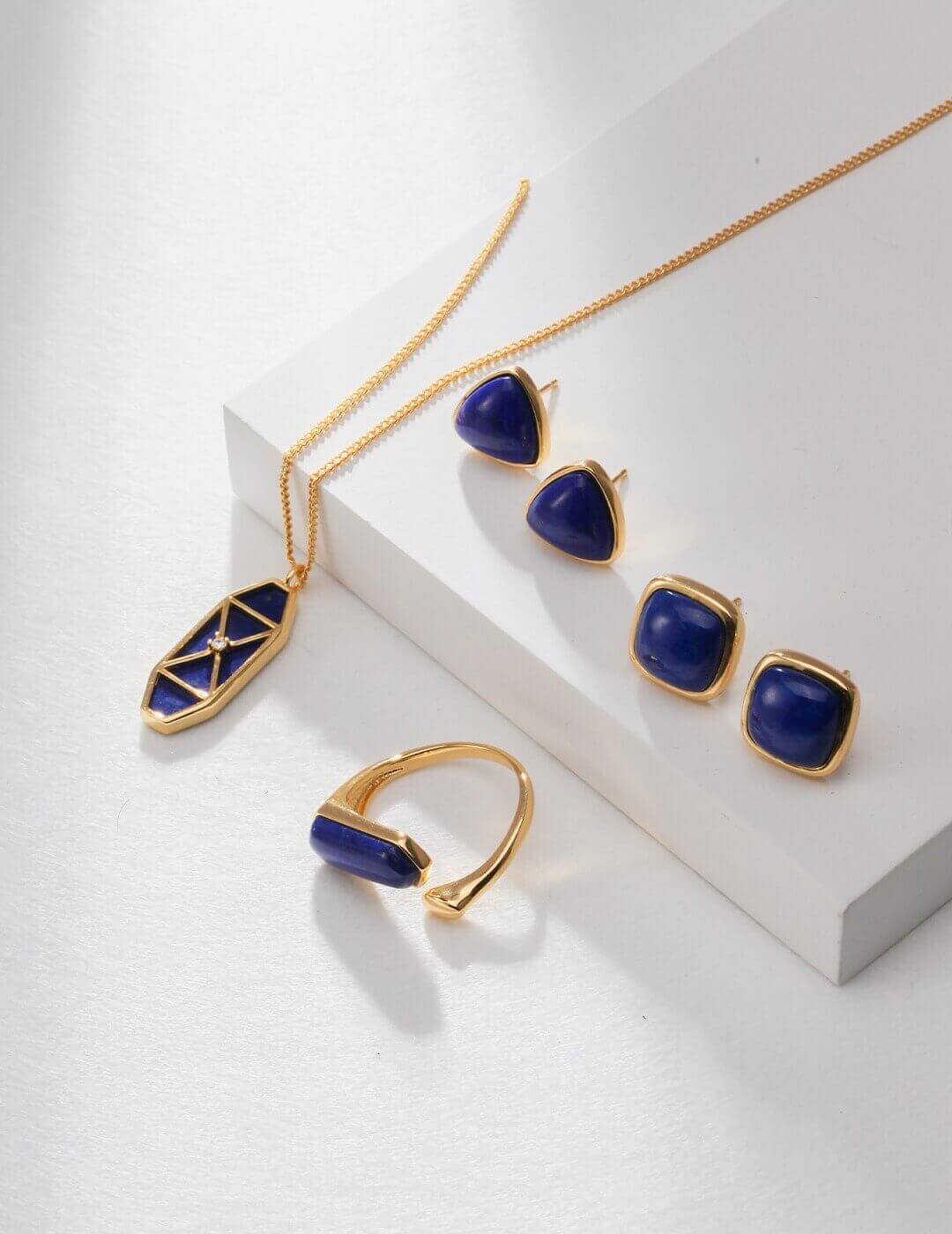 Natural Lapis Lazuli earrings showing deep blue color variation in different lighting conditions.