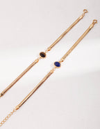 Lapis Lazuli and Tiger's Eye bead bracelet flat lay display on neutral background.