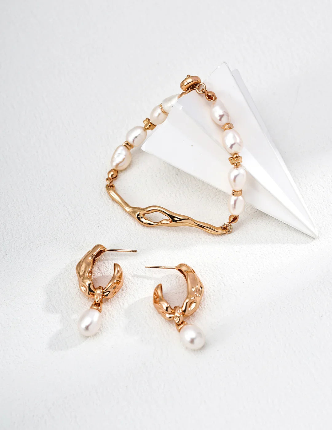 Styling the minimalist Lava Bracelet stacked with a earrings for a layered look.