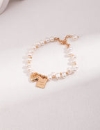 Detail shot highlighting the intricate design of the gold-plated charms.