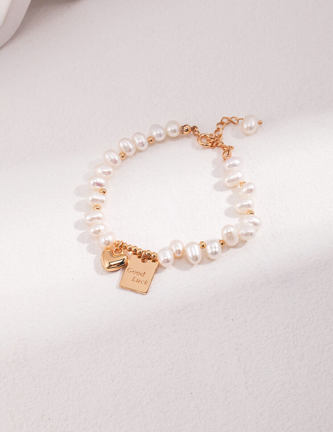 Detail shot highlighting the intricate design of the gold-plated charms.