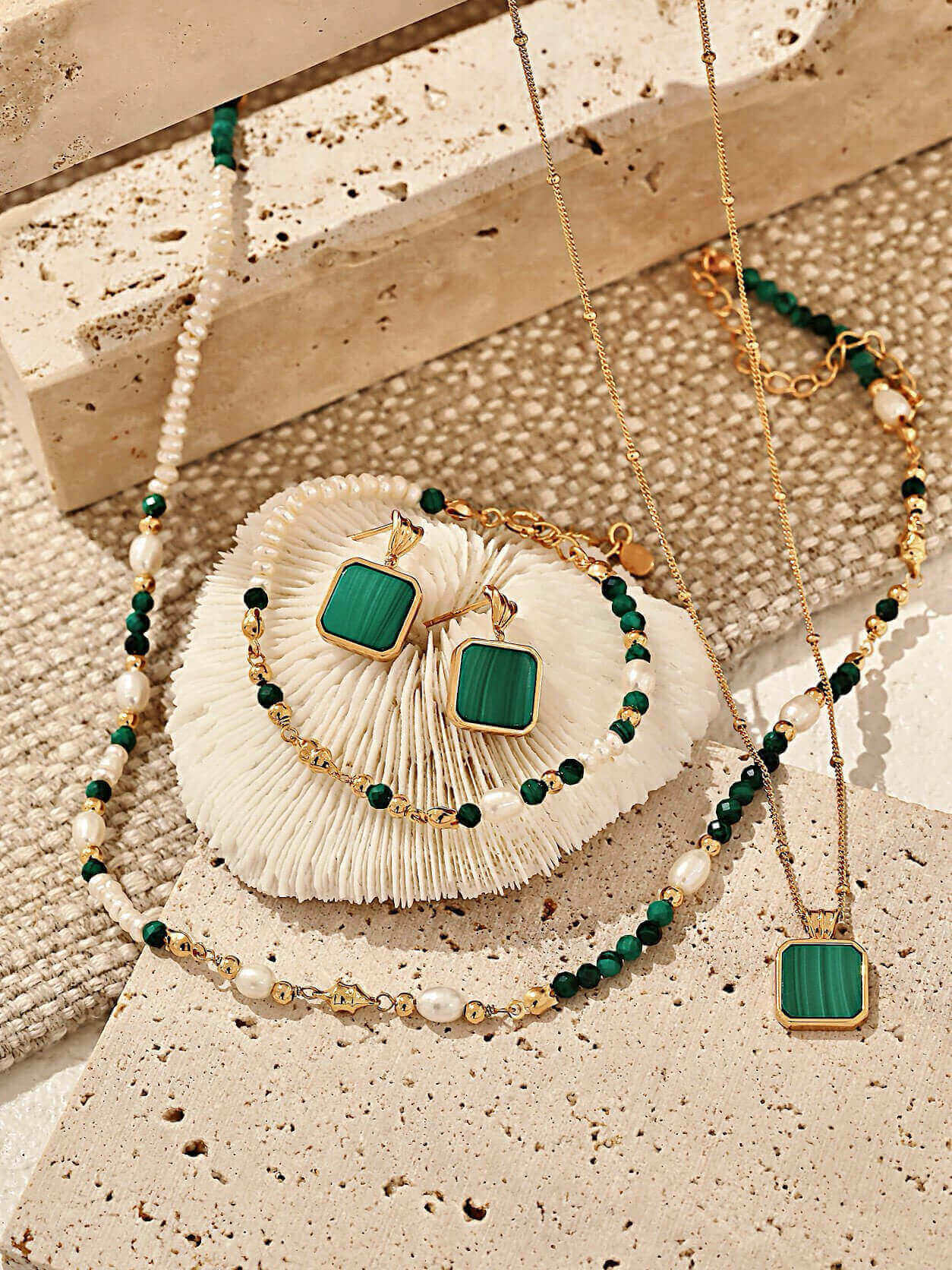 Malachite and sterling silver earrings catching the light, exuding a fresh and romantic elegance.