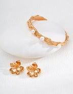 Side profile view of the floral stud earrings worn on the ear.