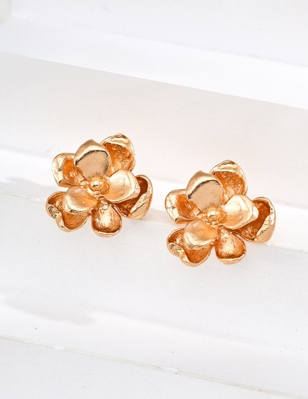 Front view of minimalist floral stud earrings in vintage gold S925 silver.