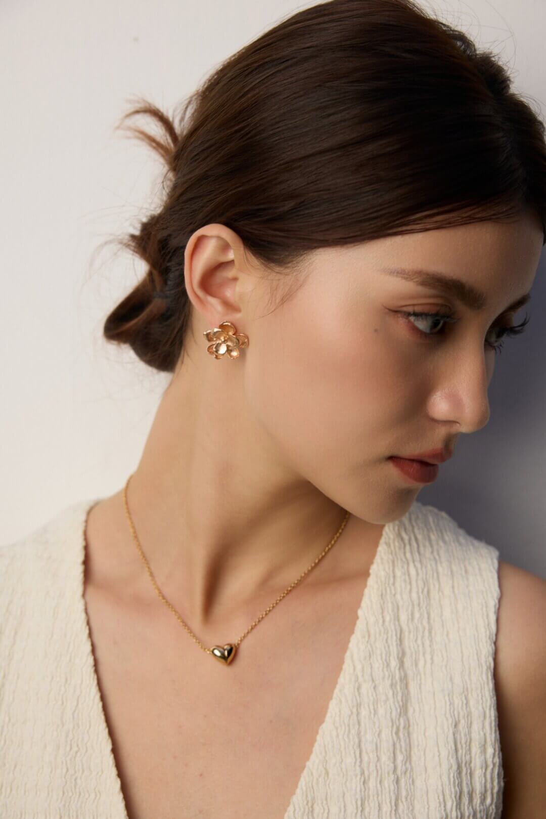 Floral studs paired with an elegant evening dress, showing versatility.