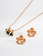  A pair of minimalist floral stud earrings displayed on a neutral background.