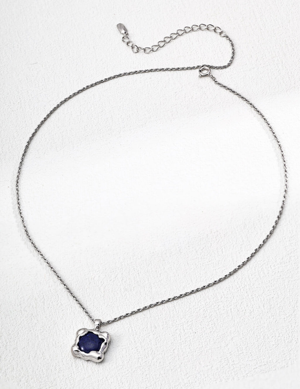 Lapis lazuli pendant necklace with classic silver frame.