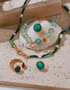 Flat lay composition featuring the minimalist malachite stud earrings alongside other minimalist jewelry
