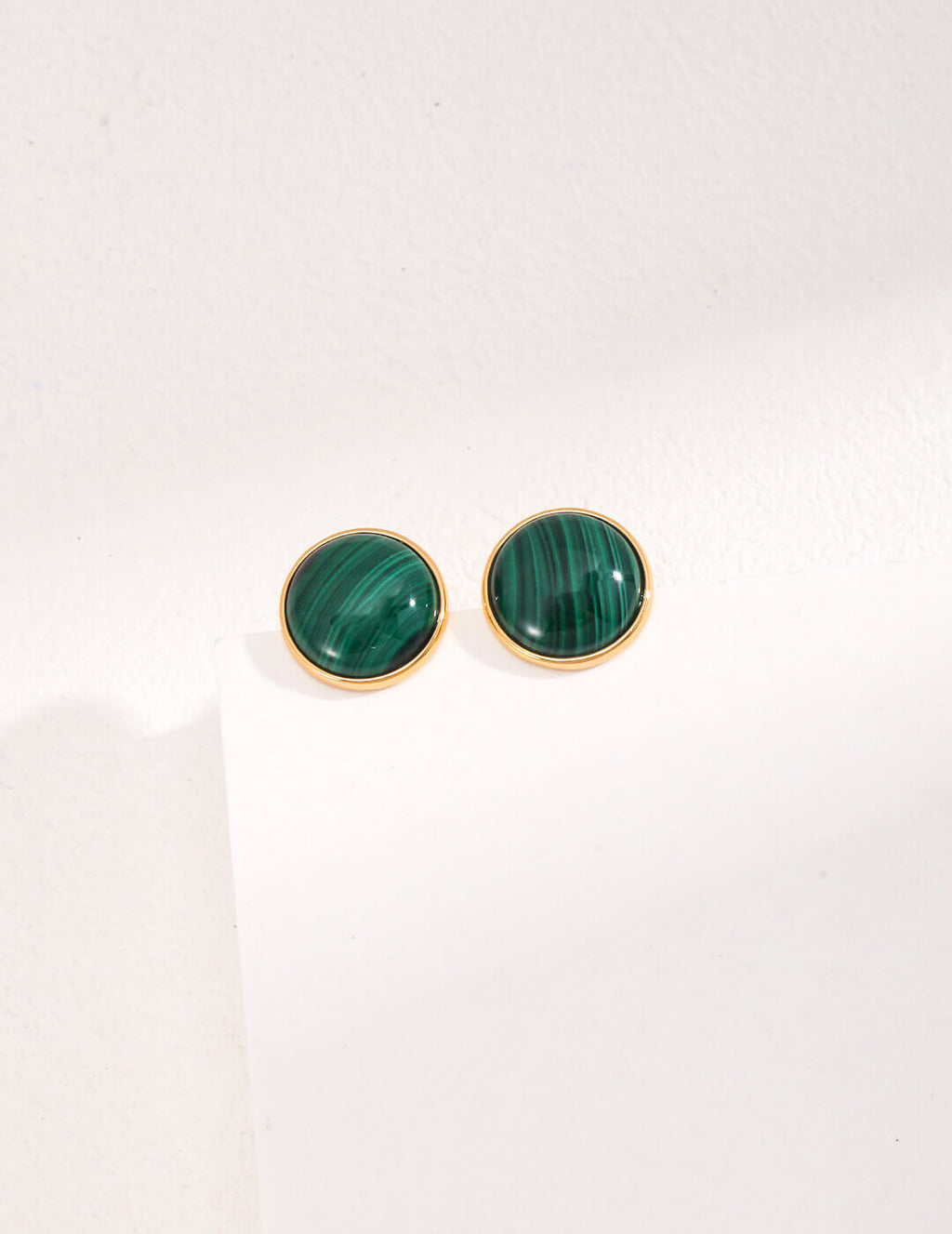 Front view of minimalist French S925 sterling silver malachite stud earrings on a white background