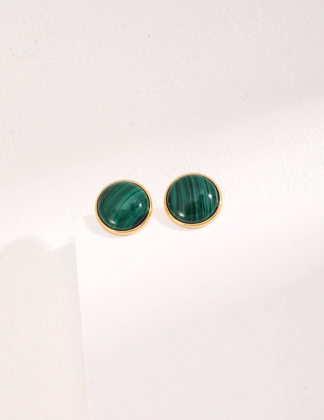 Front view of minimalist French S925 sterling silver malachite stud earrings on a white background