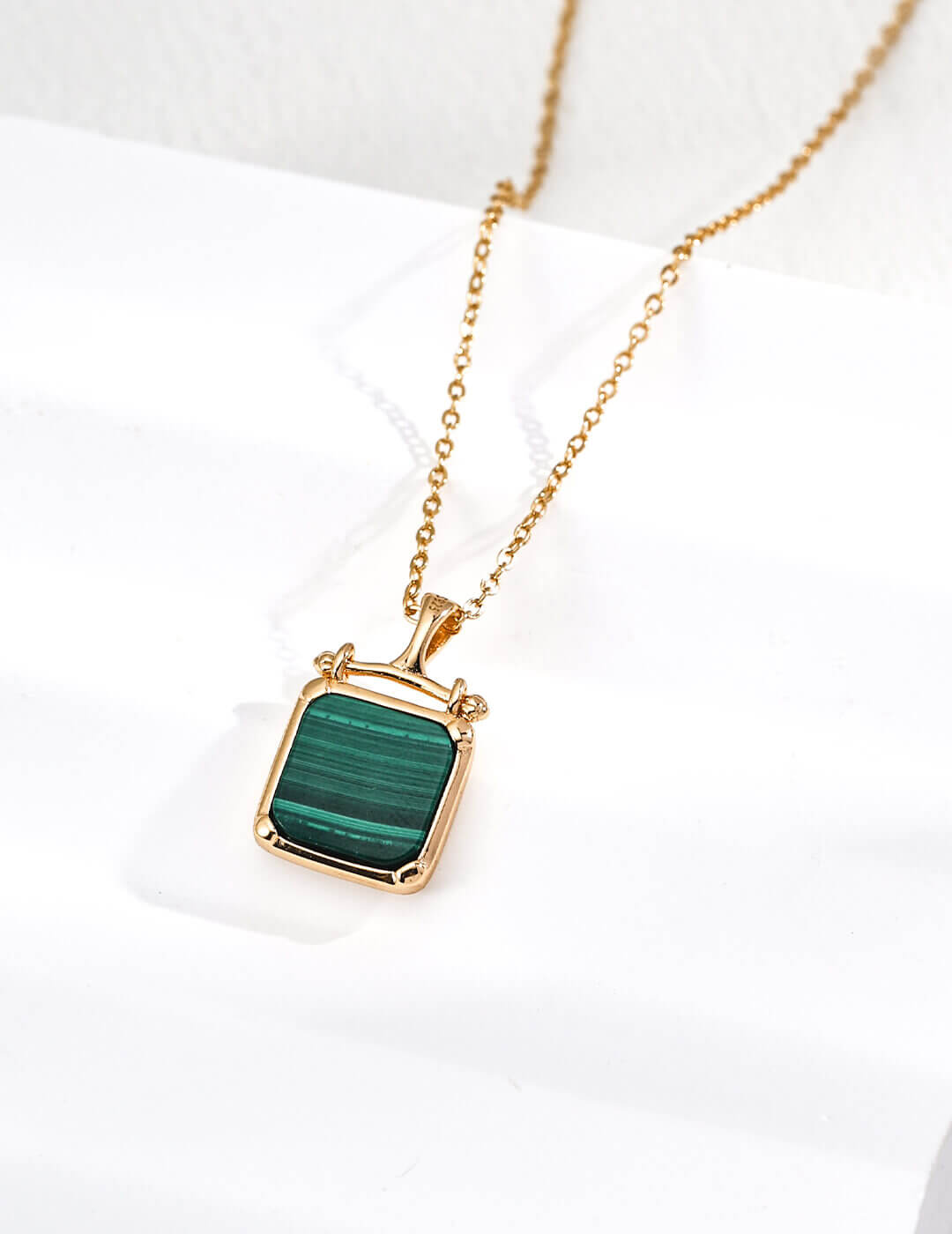 Minimalist design malachite pendant showcasing modern sophistication in sterling silver craftsmanship.